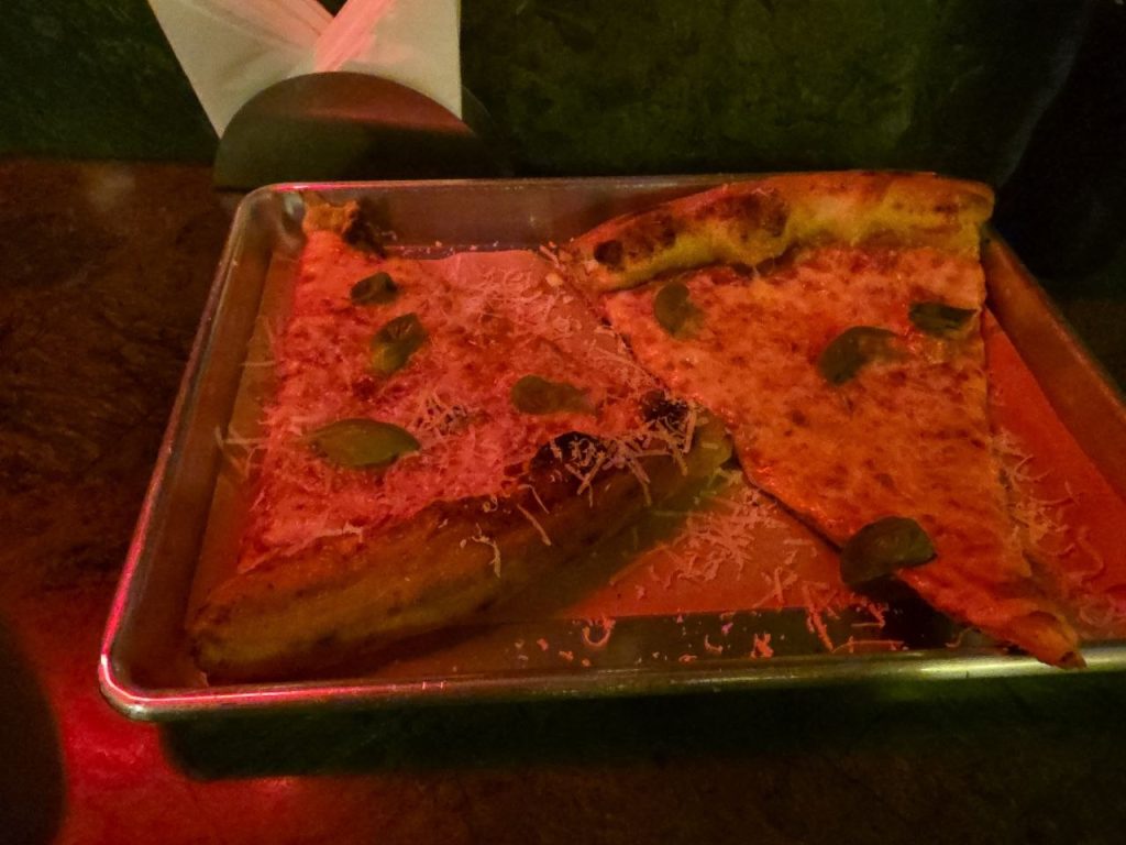 Two large New York style slices on a tray at Pull Me Pizzeria in JVC