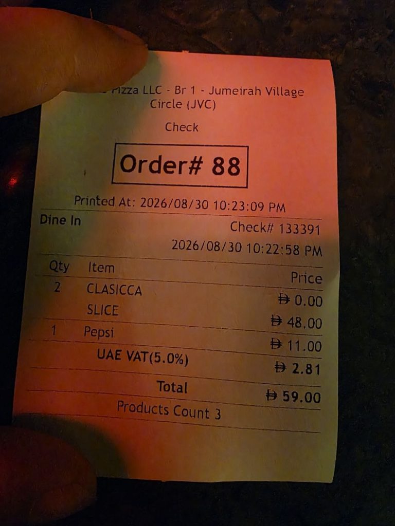 Receipt from Pull Me Pizzeria JVC showing two classic slices at AED 48